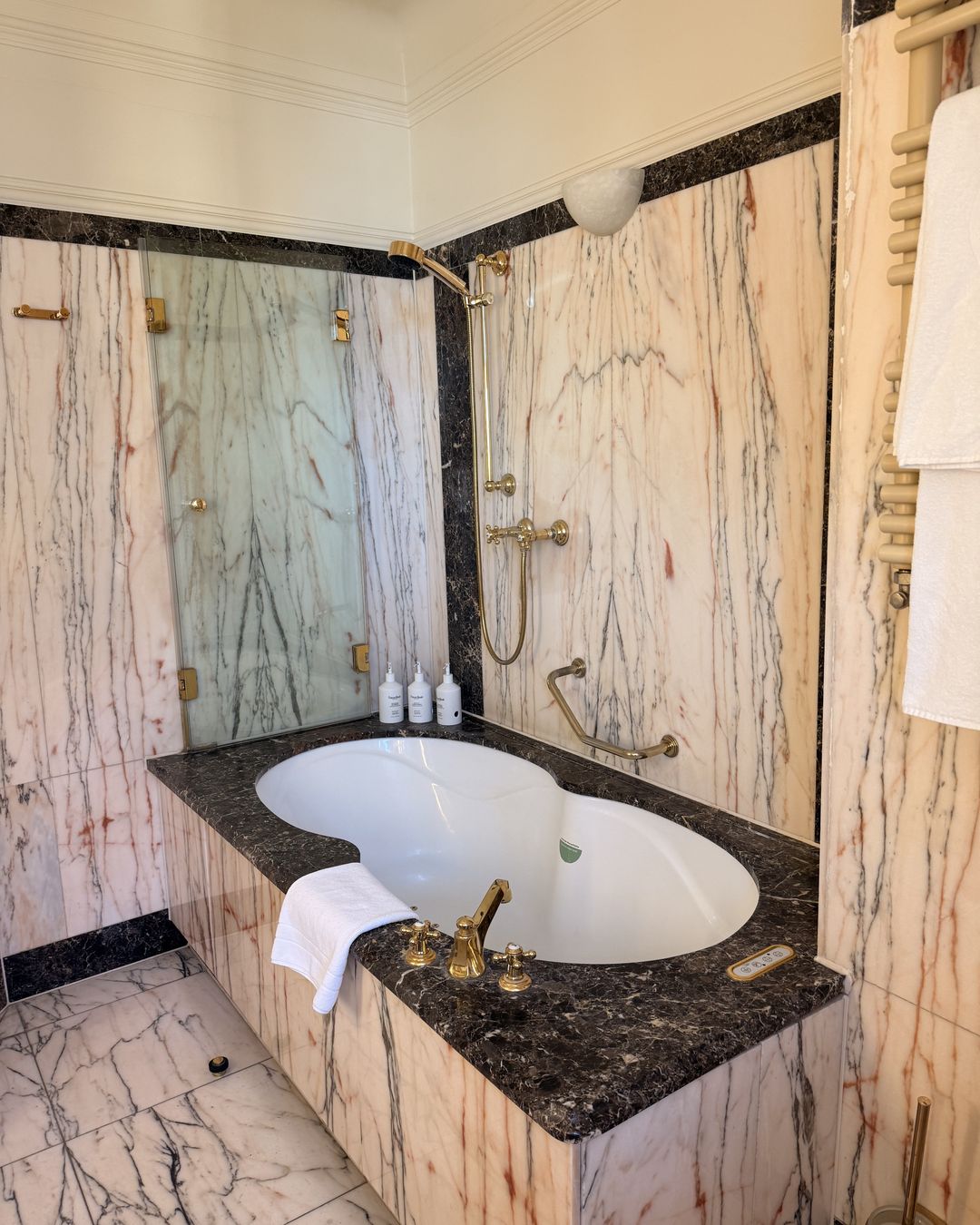 The marble bathroom of a Gewandhaus Dresden guest room, with a freestanding tub