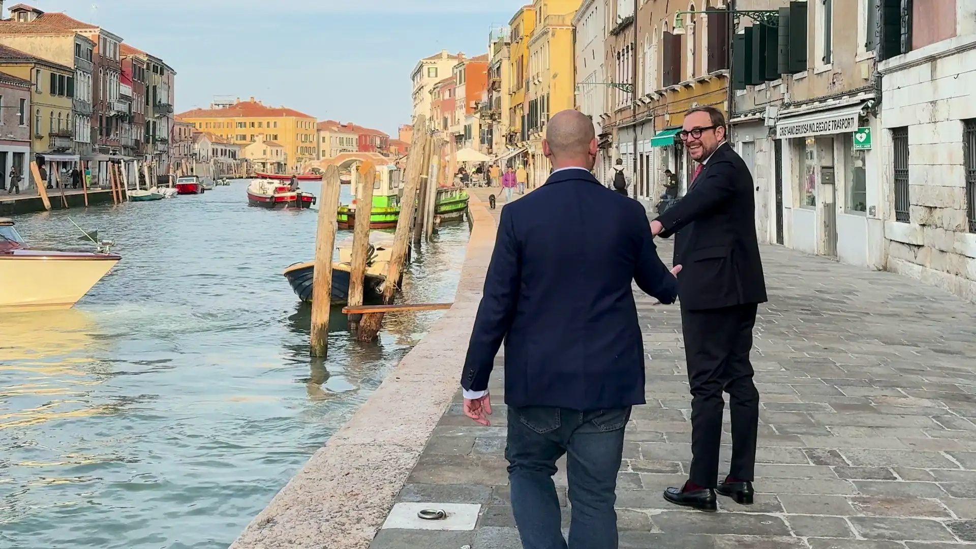 Gay couple walking hand in hand along a canal in Cannaregio, Venice
